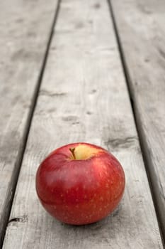 Ripe red apple on old wooden table, with copy space.