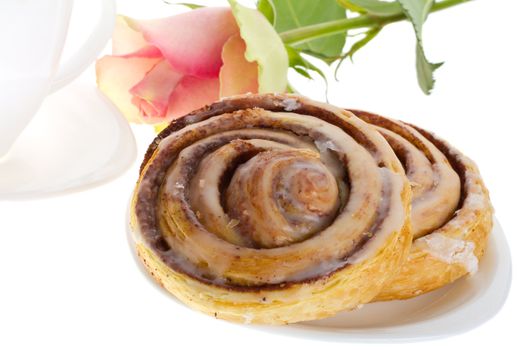 close-up cake with cinnamon, tea and rose, isolated on white