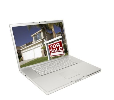 Home for Sale Sign & New Home on Laptop Isolated on a white Background.