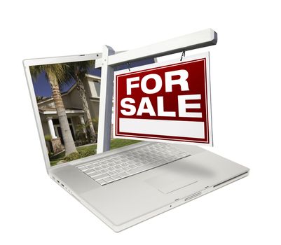 Home for Sale Sign & New Home on Laptop Isolated on a White Background.