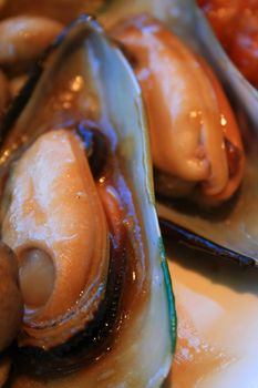 Close up of the cooked mussels on a plate.