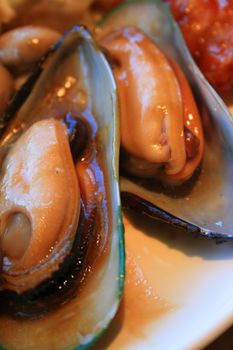 Close up of the cooked mussels on a plate.