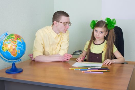 The girl and brother with color pencils