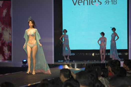 CHINA, SHENZHEN, GUANGDONG PROVINCE - APRIL 5, 2009:  The Fourth Shenzhen International Brand Underwear Fair with fashion show. Female and male models presents underwear and sexy costumes.