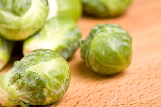 close up of brussel sprouts on a wood cutting block