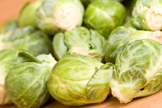 close up of brussel sprouts on a wood cutting block