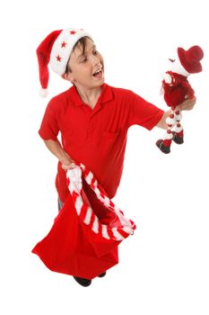 A boy holding a Christmas sack and a toy snowman.  White background.