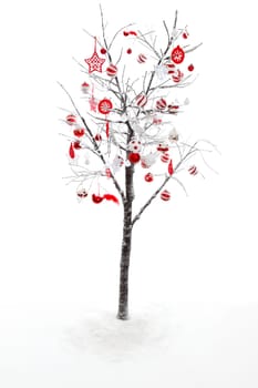 Snow covered branches and twigs of a deciduous tree is decorated with red and white Christmas baubles