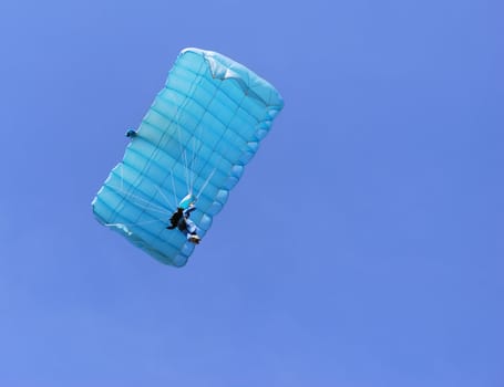 A blue parachute on a bright sunny day.