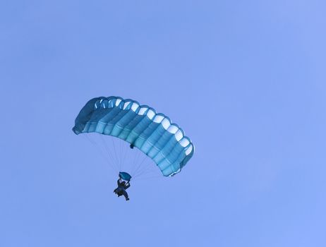 A blue parachute on a bright sunny day.