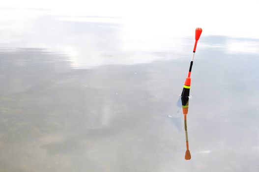 bobber or fishing float in water showing success concept