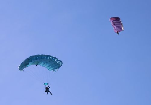 Two parachutes on a bright sunny day.