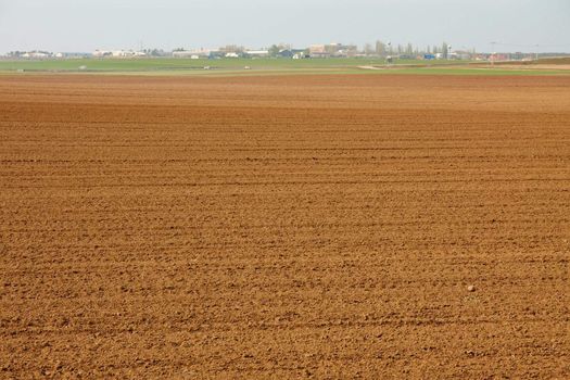 Agricultural field with fertile brown soil