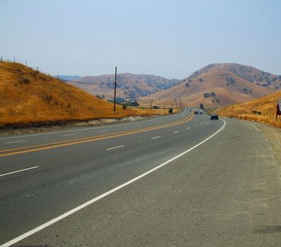 Long infinite road on a sunny day.