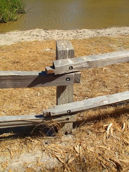 Close up of a rustic fence in a forest.