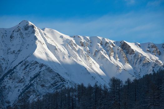 High mountain range with snow and clear blue sky