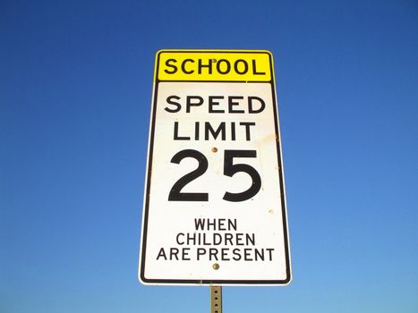 Speed limit road sign over blue sky.