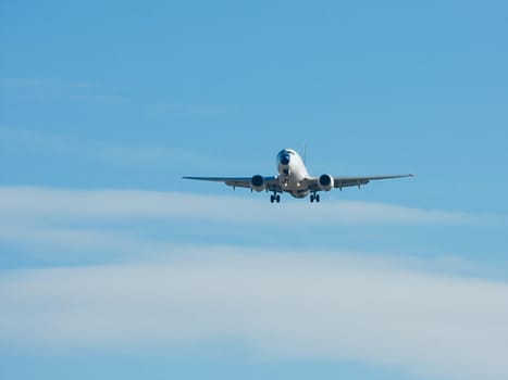 Plane landing against blue sky