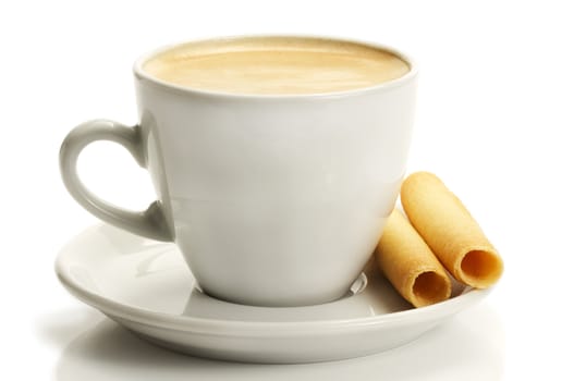 coffee in a white cup with rolled cookies or piroulines on white background