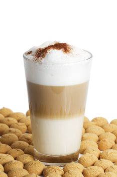 latte macchiato between a lot of amarettini on white background