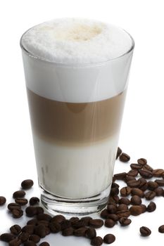 latte macchiato with coffee beans on white background