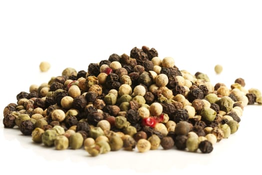 a lot of mixed peppercorns on white background