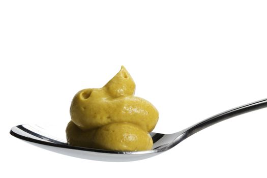 mustard on a spoon isolated on white background