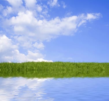 Beautiful green grass against blue sky and clouds representing perfect land.