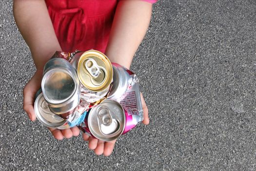 Recycling Aluminum Cans in a Child's Hands