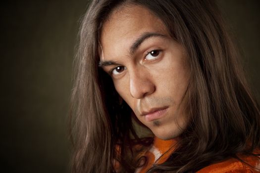 Closeup Portrait of a Handsome Young Man with Long Hair