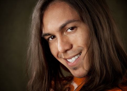 Closeup Portrait of a Handsome Young Man with Long Hair