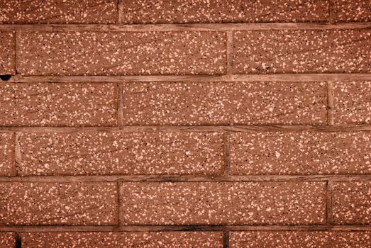 It is a dark brown stone wall.