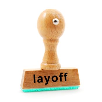 layoff stamp in business office showing unemployment concept