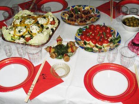 The table served with salads, plates and napkins