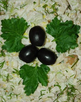 Salad decorated with olives and green parsley leaves