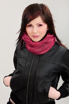 Brunette girl in leather jacket on isolated white