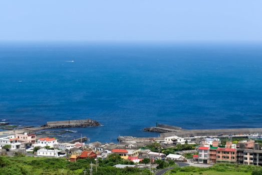 It is a beautiful seascape of small town and blue sea water.