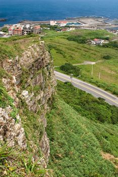It is a green cliff and small town near the sea.