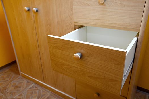 Wooden cabinet with open drawer