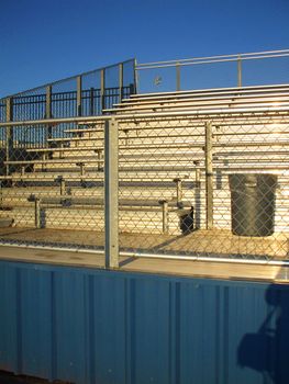 Empty bleachers on a stadium in a park.