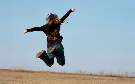 Girl jumping on a field