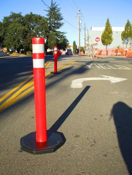 A row of road cones next to a construction site.