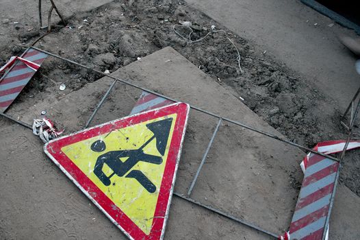 Construction roadsign laying on the ground