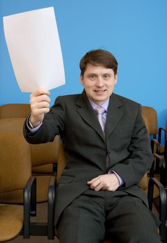 The young man in a hall at conference