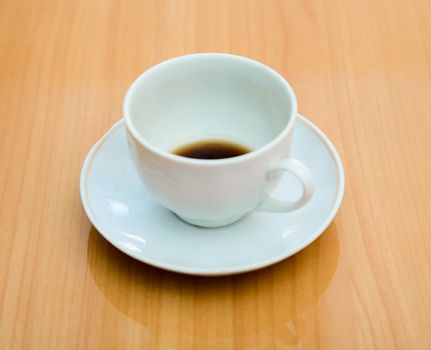 Cup with not drunk up coffee on a table