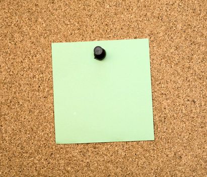 Stickers pinned to a brown cork board