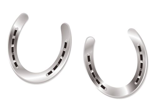 Two silver horseshoes with light reflection lucky charm concept
