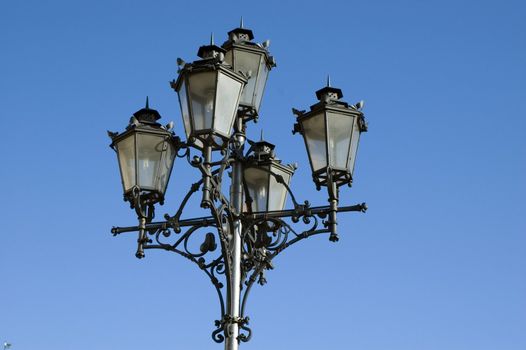 Poland, Wroclaw city - old style lantern in market square with blue sky as background.