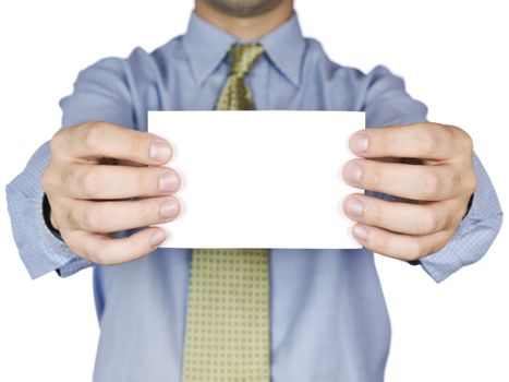 Business man holding a blank white card (focus on the card). Isolated on white.