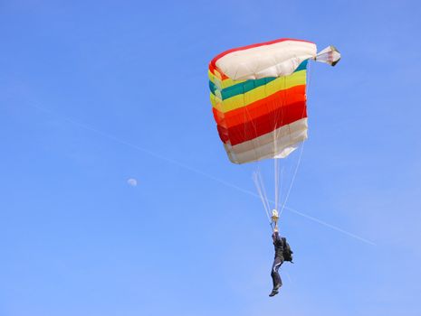 A colorful parachute in a blue sky on a sunny day